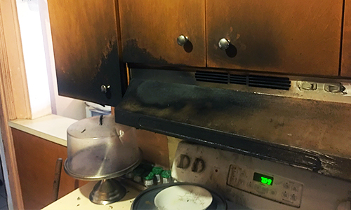 Fire damage to stove in kitchen.